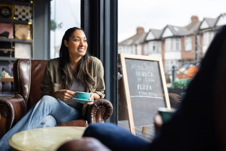Why Do People Do Dry January? An image of a woman having a coffee in a cafe.